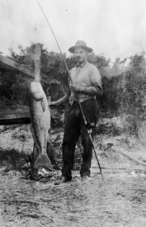 Carl Taylor with a fish and fishing pole